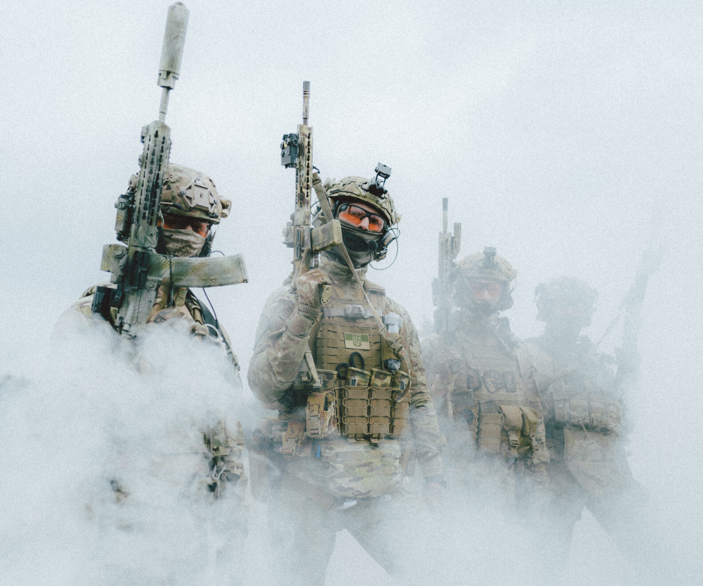 Soldiers in Ukraine walk through fog.