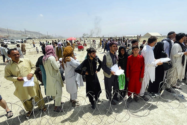 Hundreds of people gathered outside the international airport in Kabul, Afghanistan on Tuesday, Aug. 17, 2021. UC Berkeley has launched a fundraising rescue operation for Afghan scholars at risk. (AP Photo).
