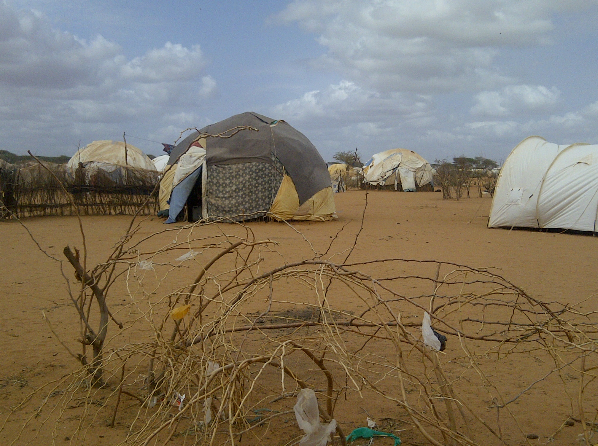 A desert-like area with several tents erected.
