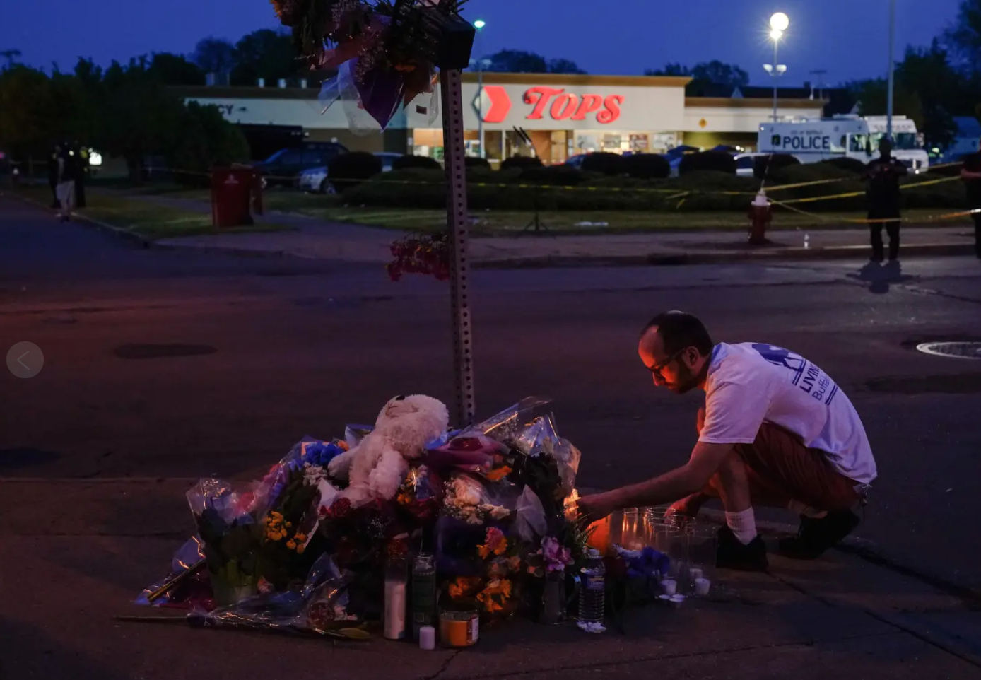 A person pays his respect outside the scene of a shooting at a supermarket, in Buffalo, N.Y., Sunday, May 15, 2022. (AP Photo/Matt Rourke).