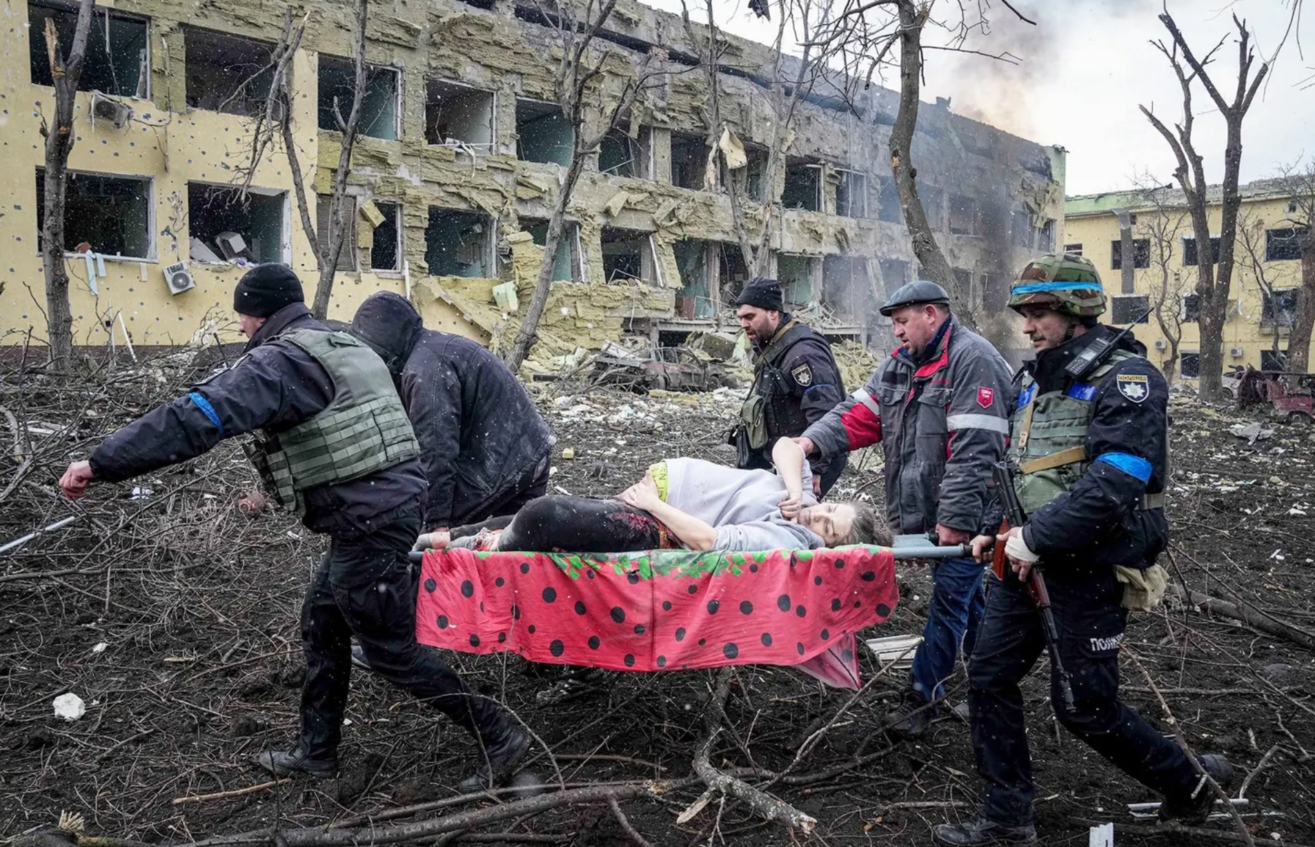 Ukrainian emergency workers carry an injured pregnant woman from a maternity hospital damaged by shelling in Mariupol, Ukraine. The baby was born dead and the mother later died.ASSOCIATED PRESS/EVGENIY MALOLETKA.