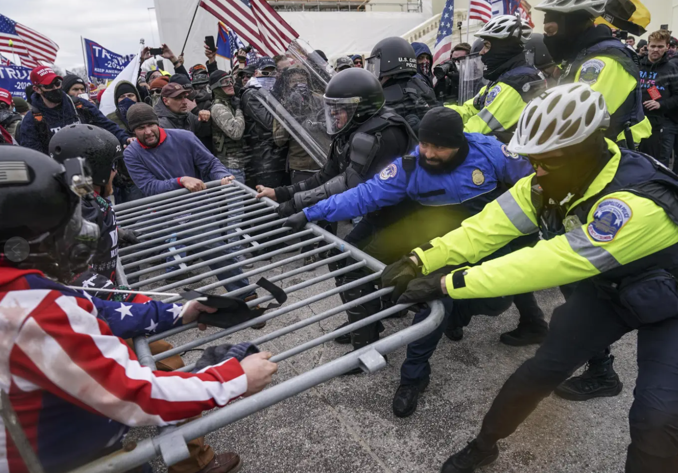 People fight over a barrier.