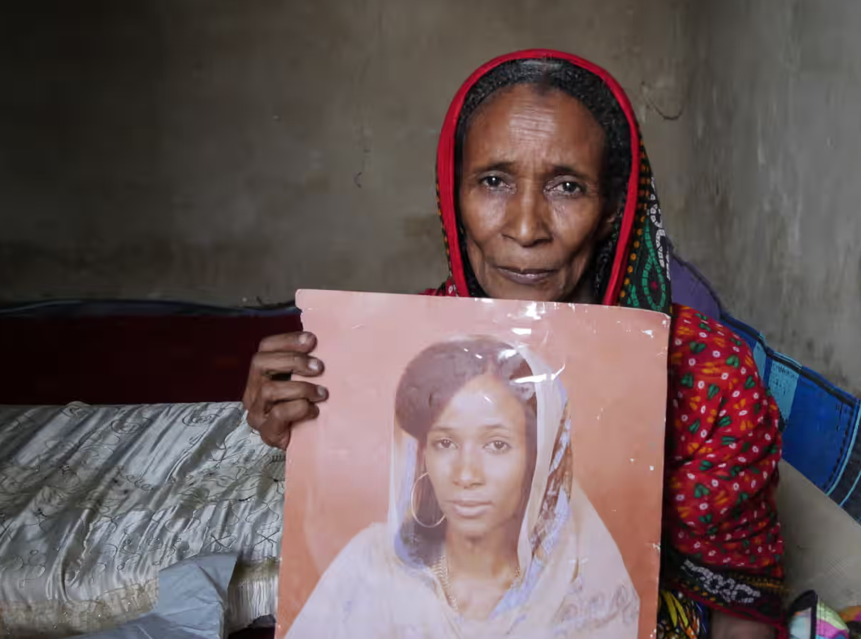 Khadidja Zidane holds a picture of her as a young woman, newly married, before she was arrested and raped by Habré. Photograph: Ruth Maclean