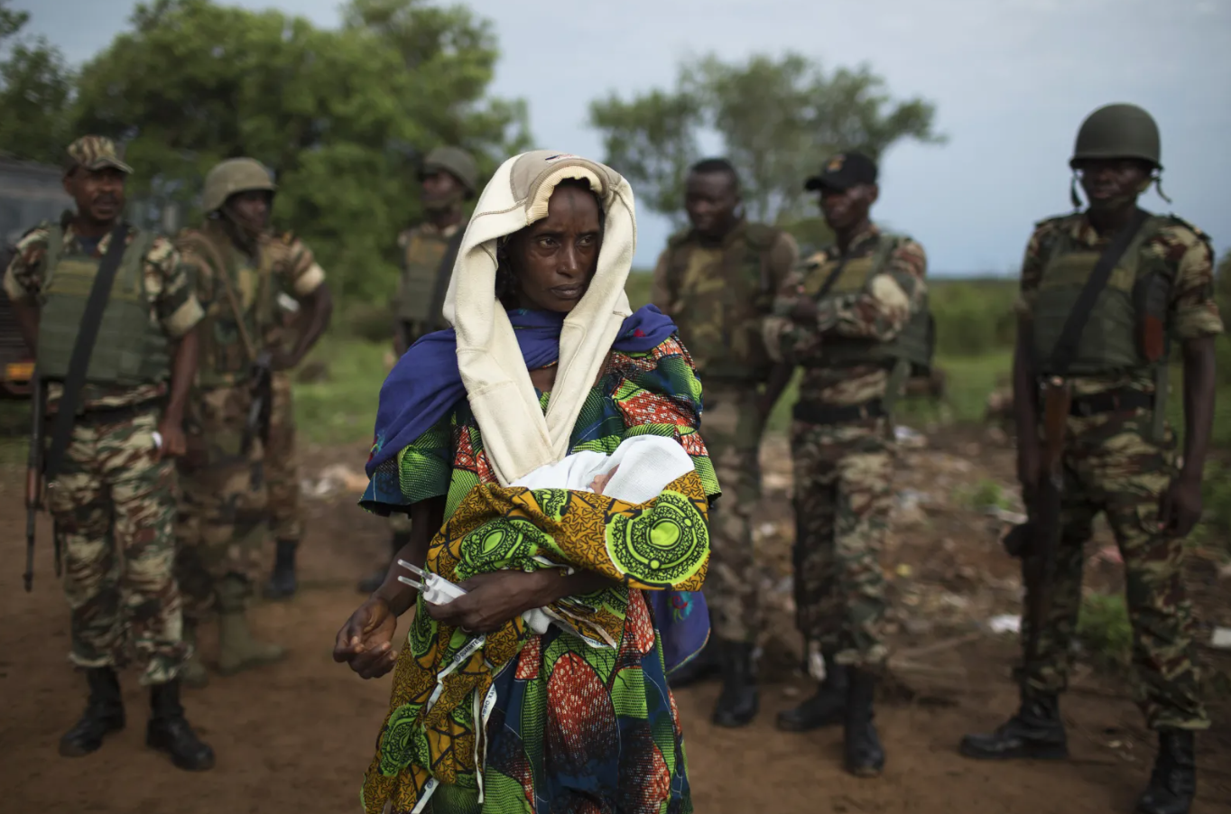 The relative of a woman that recently gave birth yesterday to twins holds one of the babies before departing towards Chad's border, escorted by troops from the African Union operation in CAR (MISCA) in the northern town of Kaga Bandoro, April 29, 2014. Siegfried Modola / Reuters