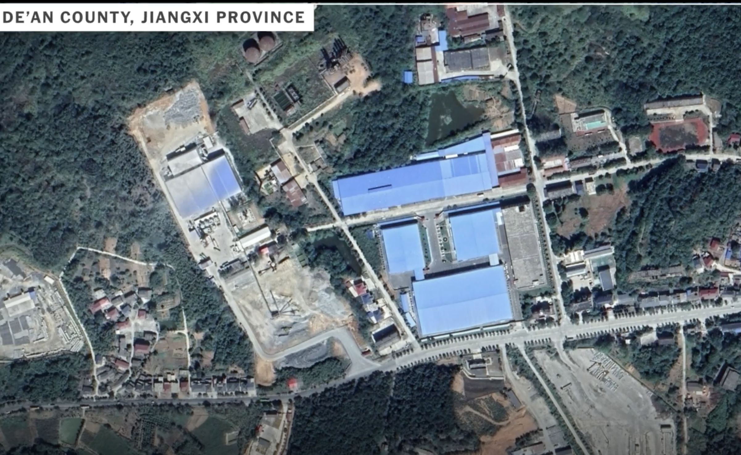 Satellite imagery showing a blue set of buildings. Text reads: 