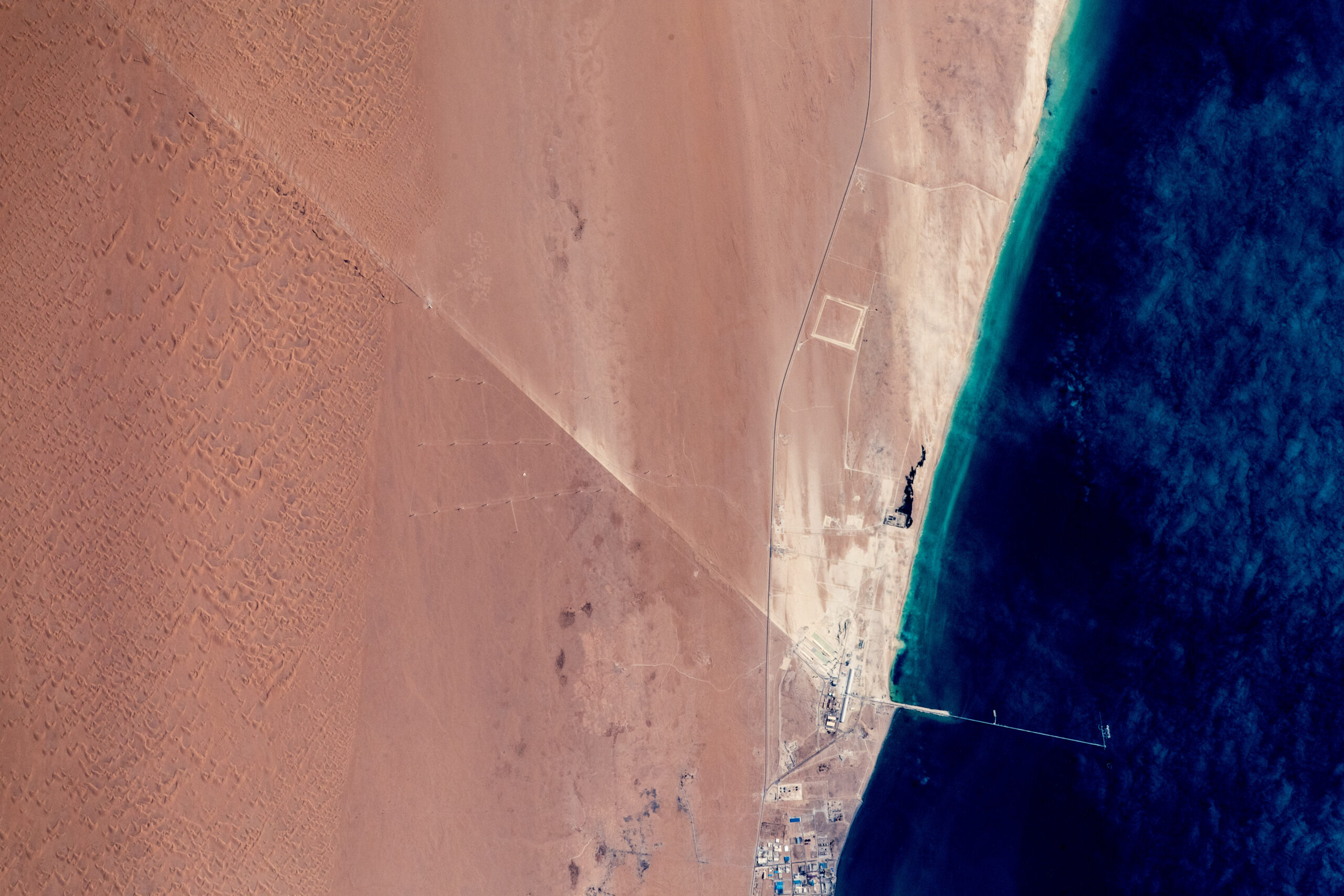 Satellite image depicting a desert and a sea.