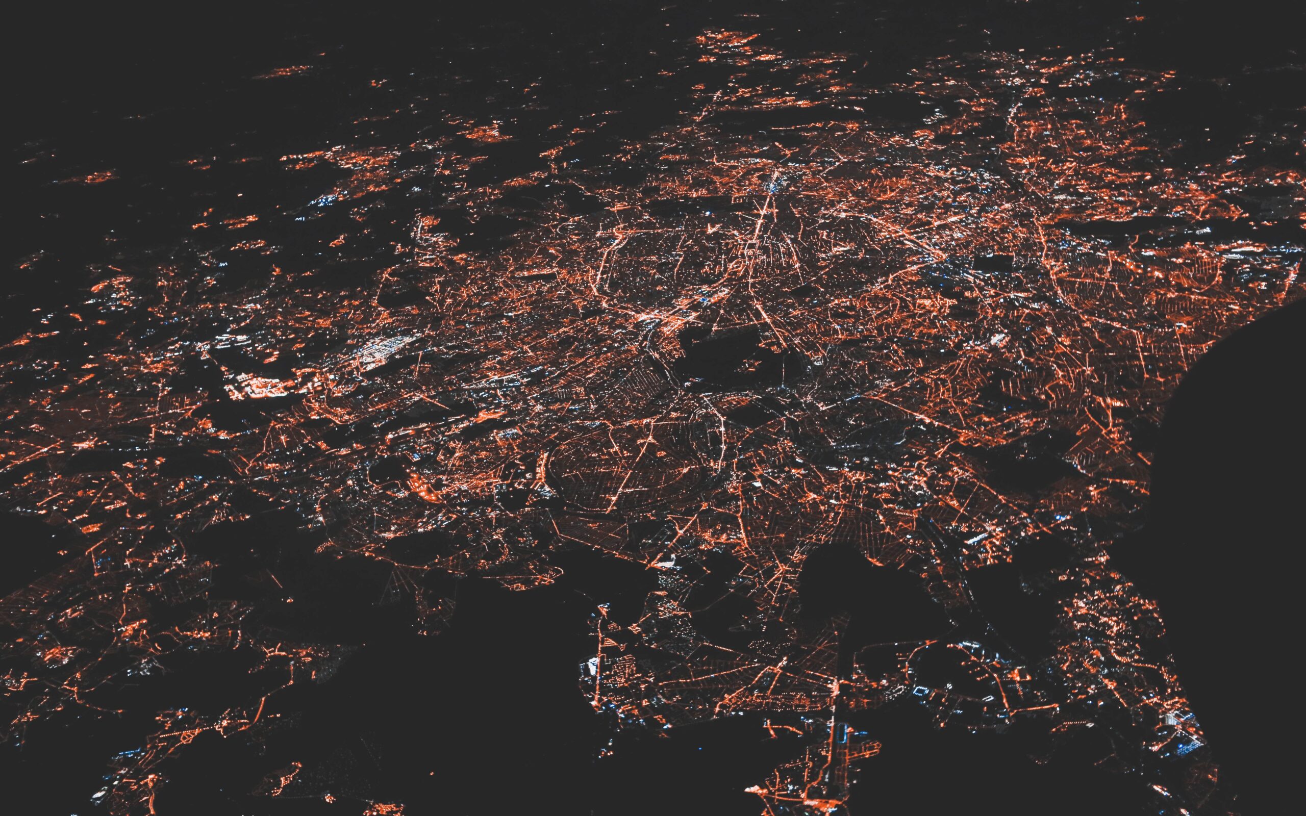 Nighttime aerial image showing ambient light over an unknown area.