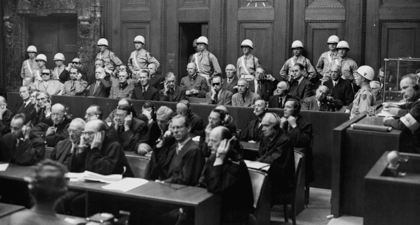 A black and white image of people in a courtroom using headsets for translation.