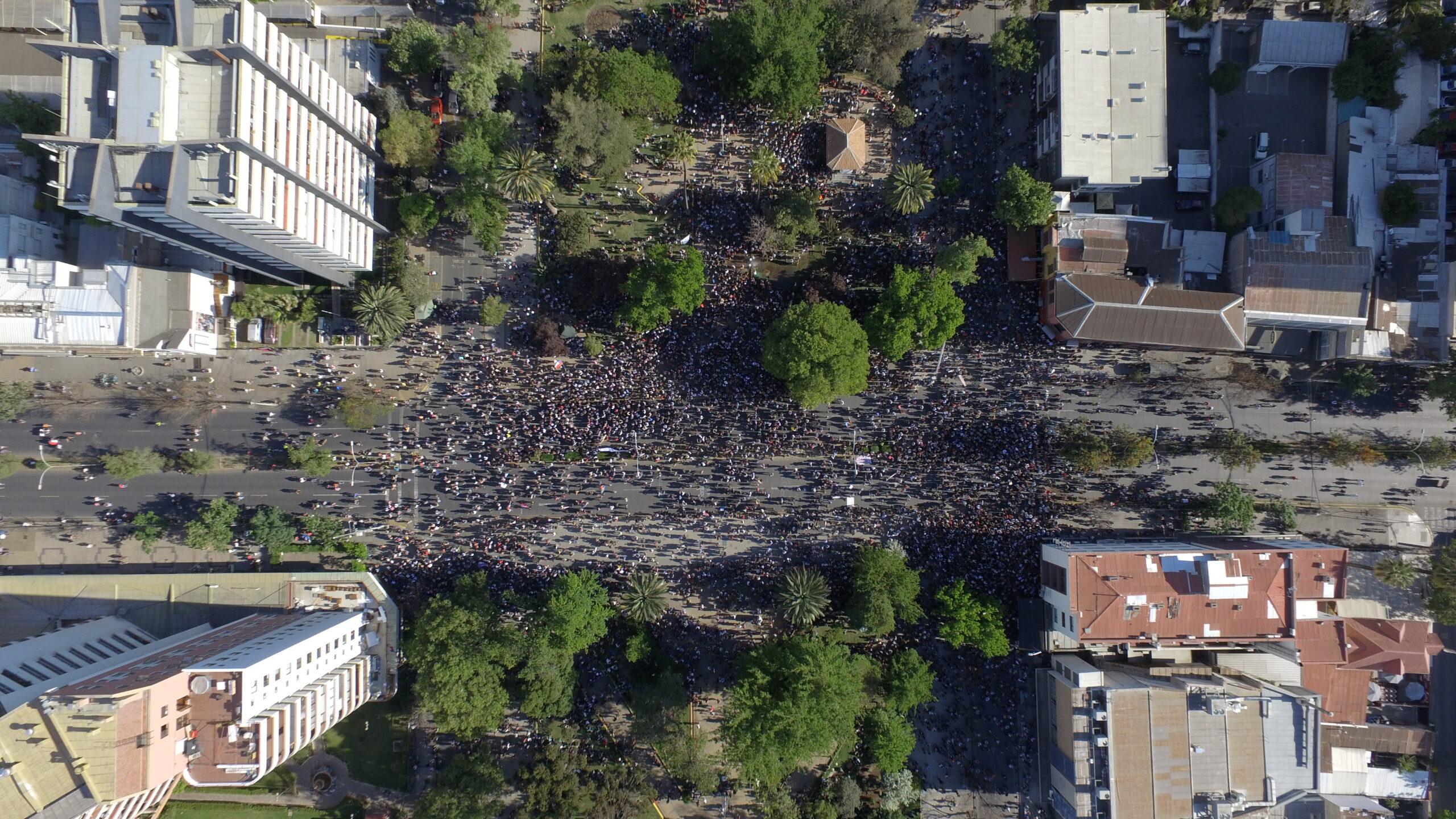 An aerial image of people marching in the streets.