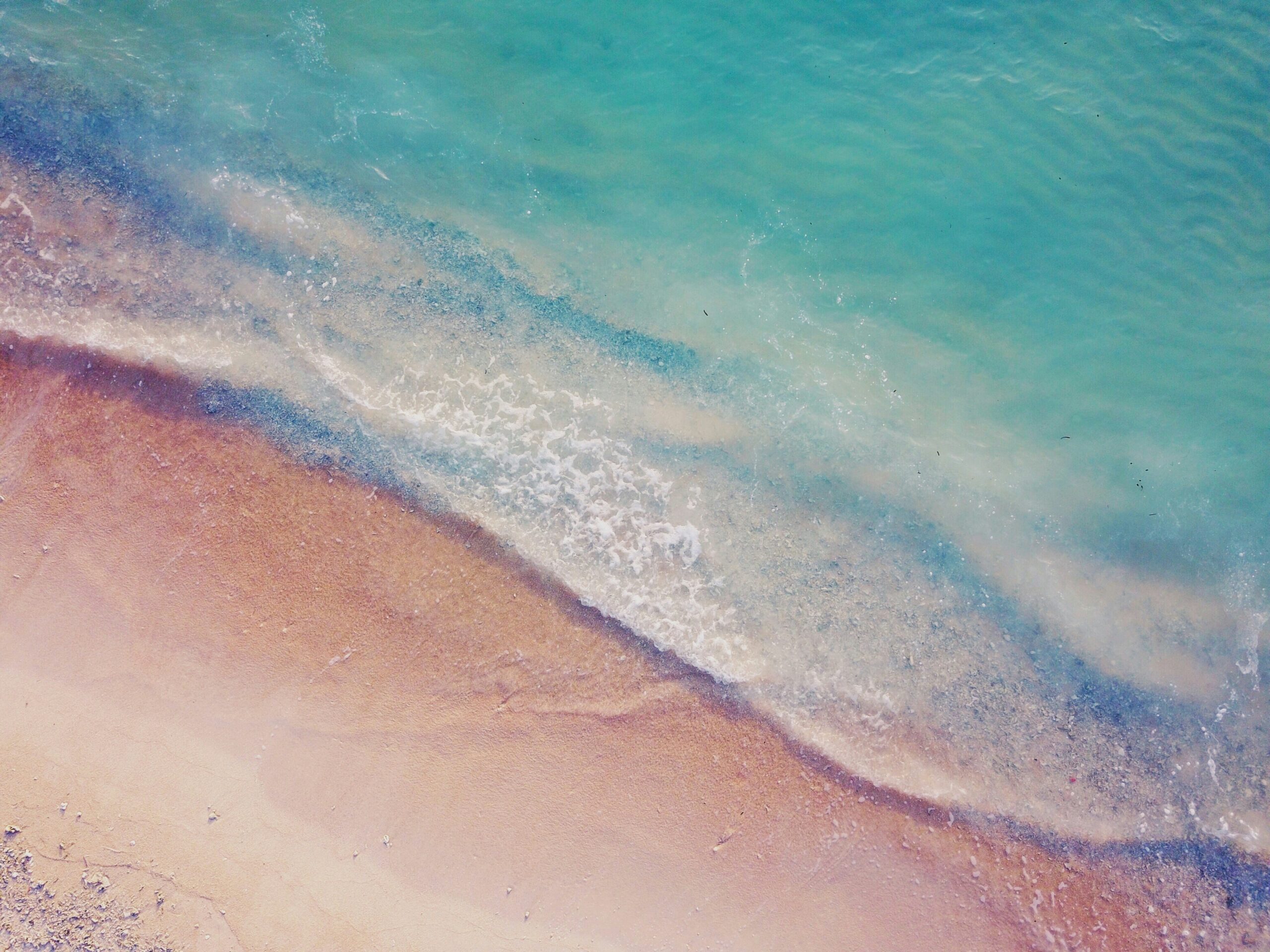 An aerial image of water and sand.