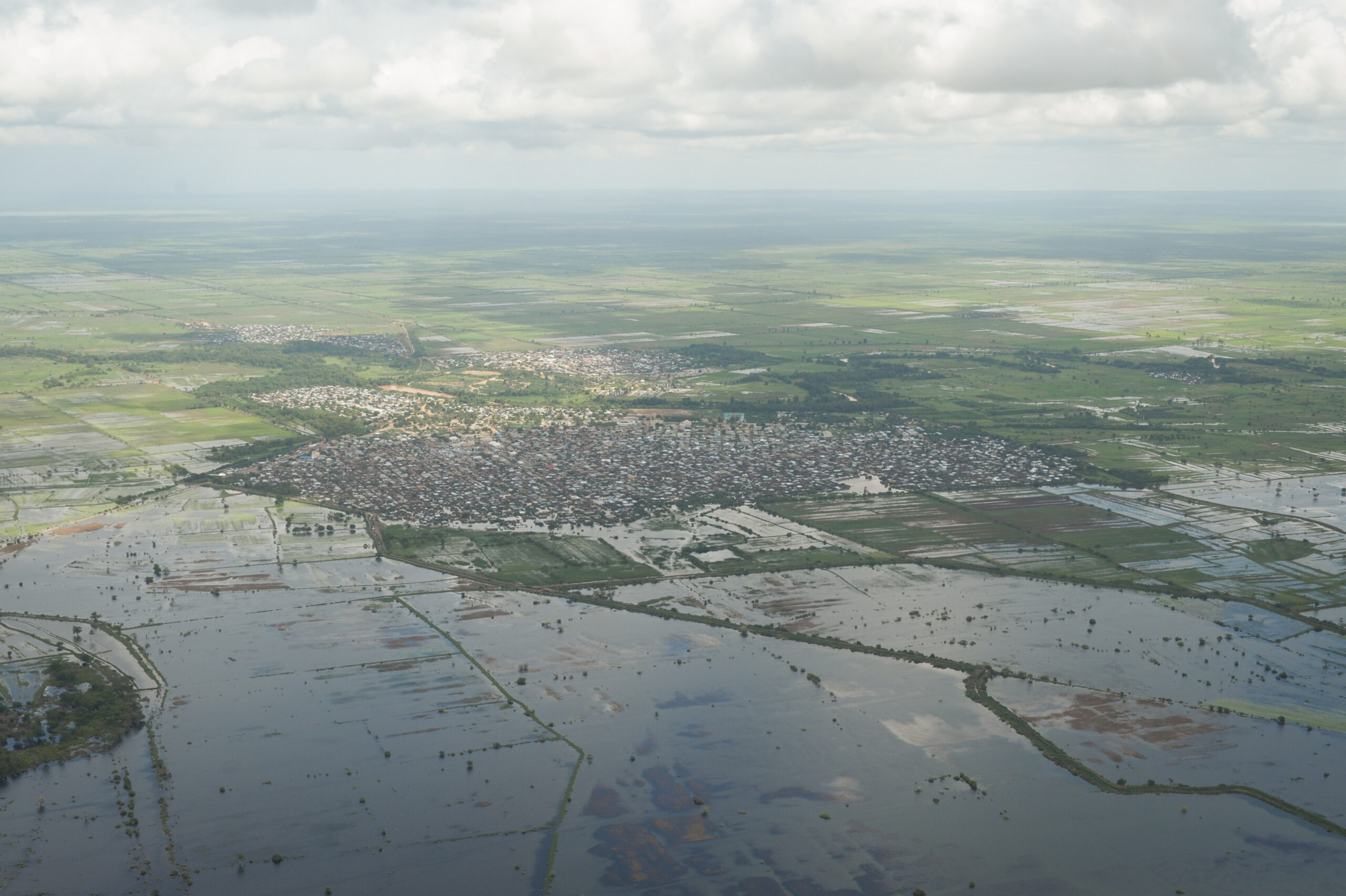 An aerial view of flooding next to a town.