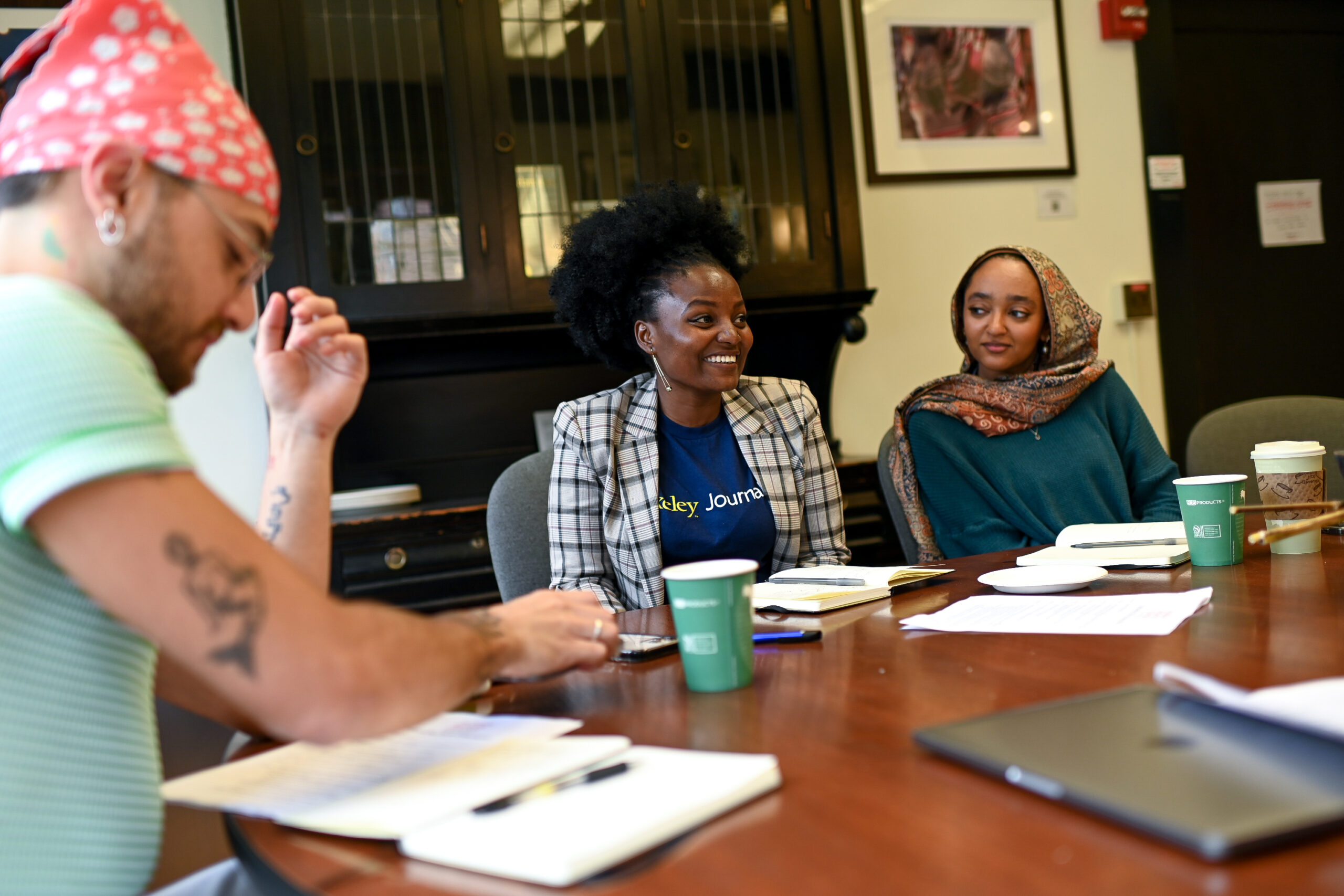 Three students sit around a table.