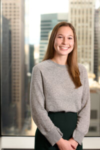 A woman smiles at the camera.